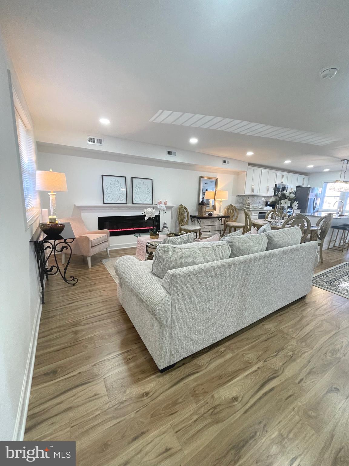 a living room with furniture and kitchen view