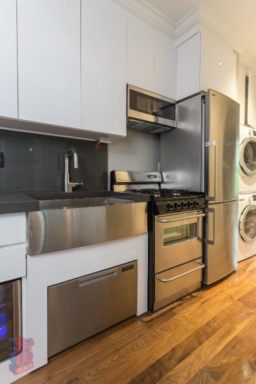 a kitchen with cabinets and steel stainless steel appliances