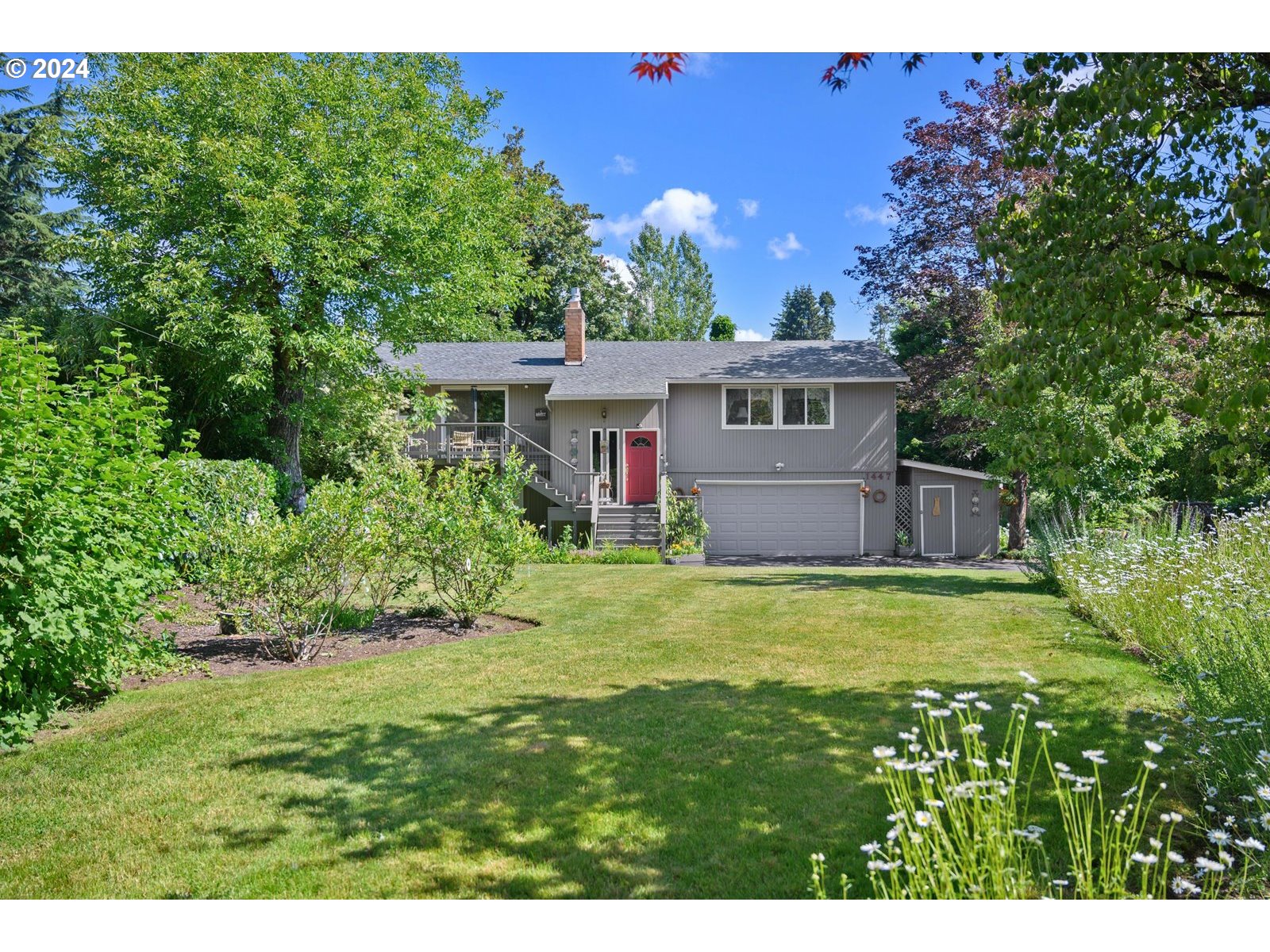 a front view of house with yard and green space