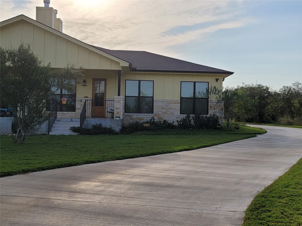 a front view of a house with a garden