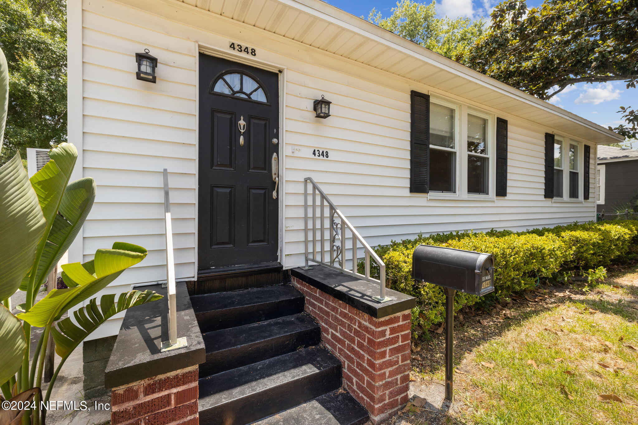 a front view of a house with outdoor seating