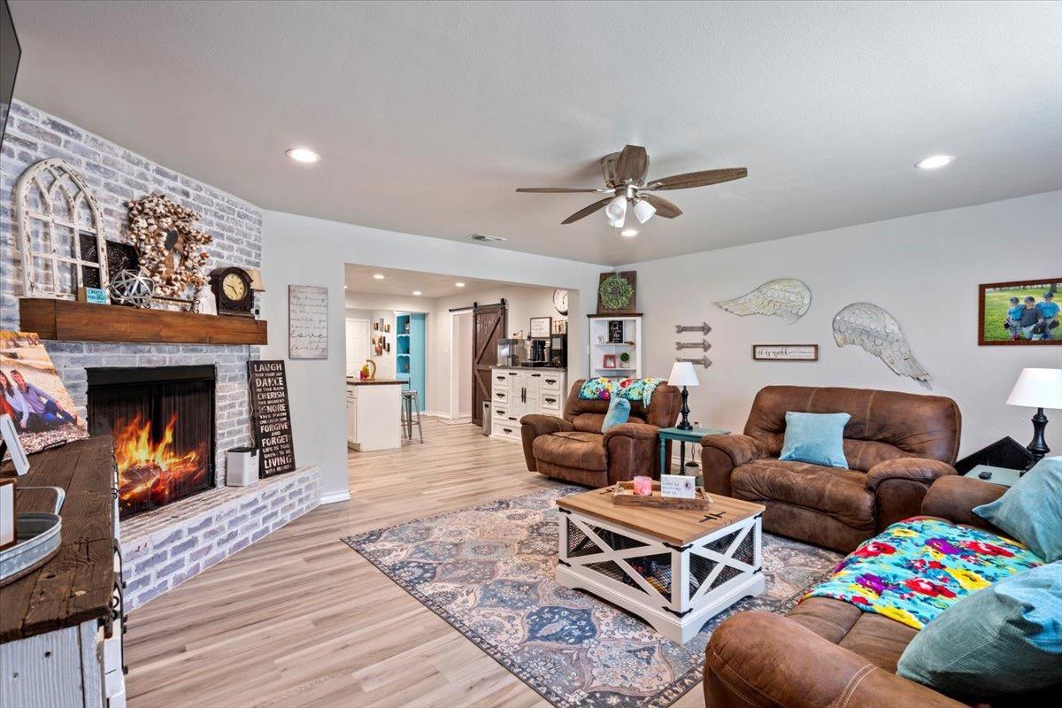 a living room with furniture fireplace and window