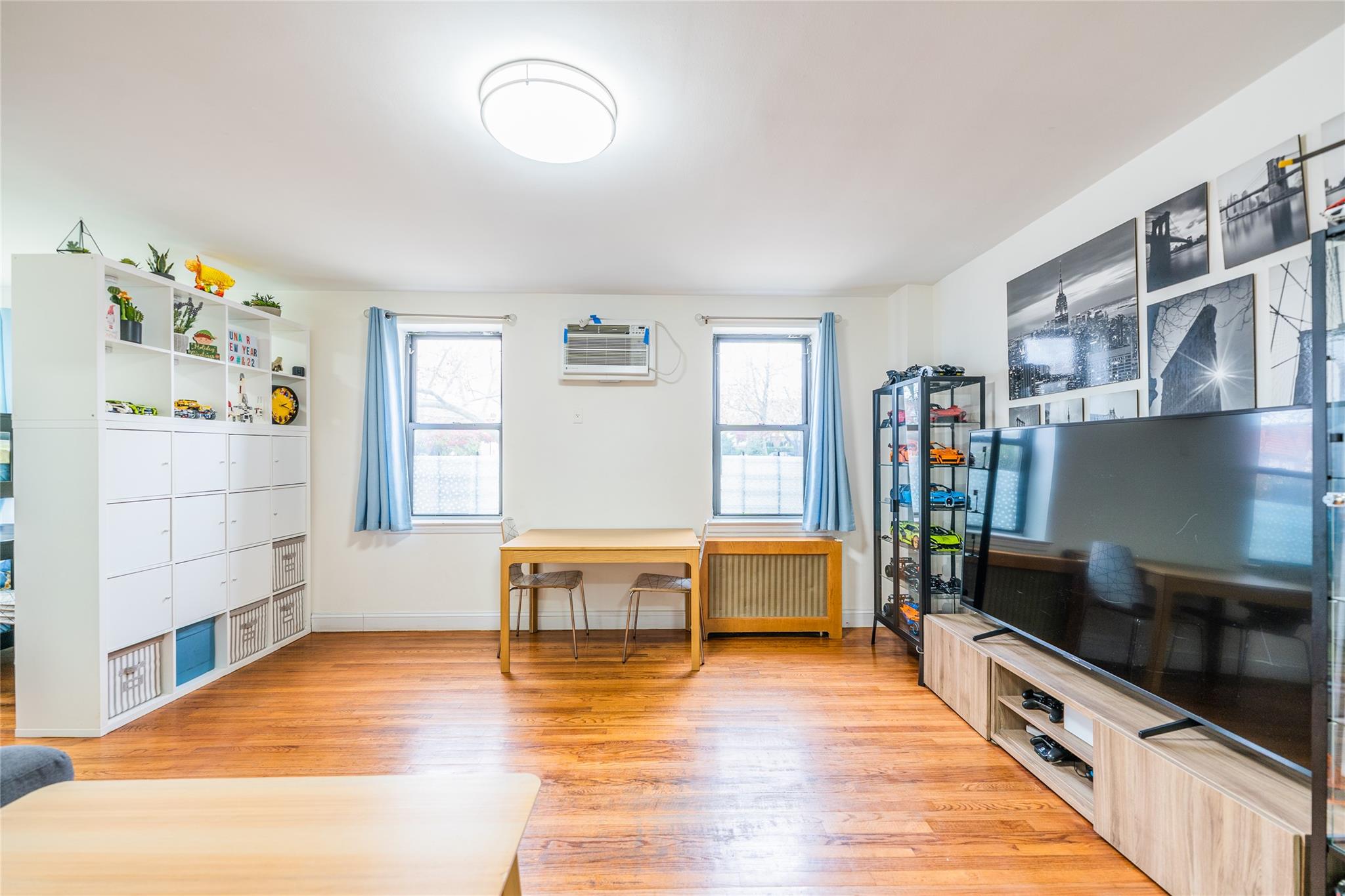 a kitchen with stainless steel appliances wooden floor and a refrigerator