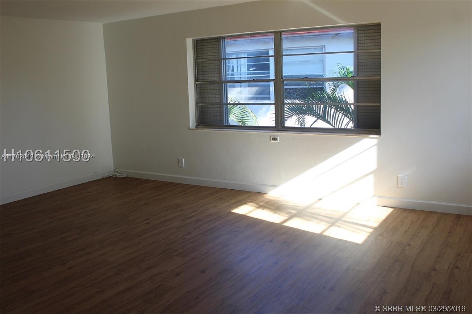 a view of wooden floor and windows in a room