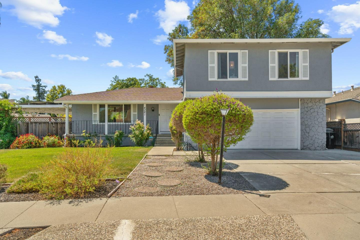 a front view of a house with garden