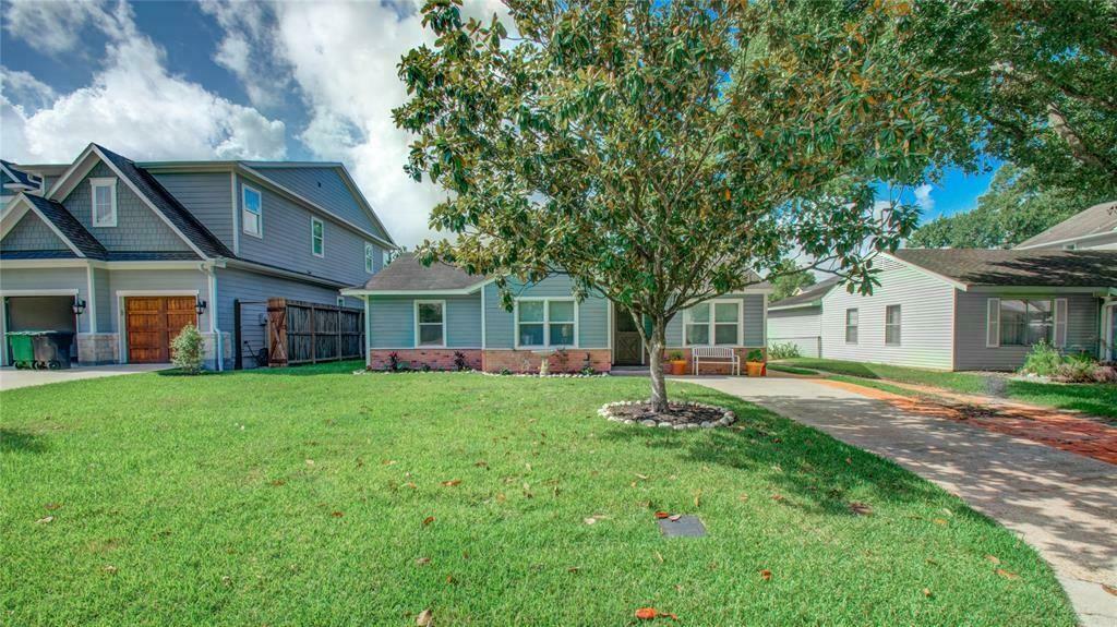 a view of a house with a yard and tree s