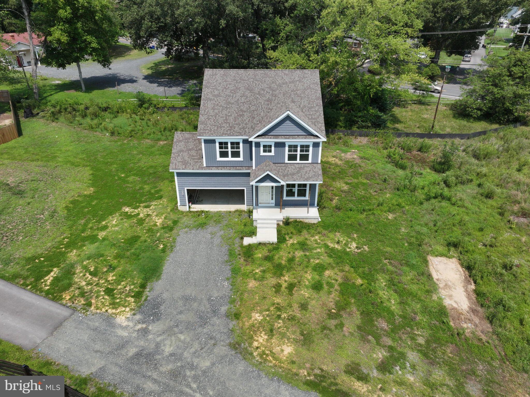 a view of a house with a yard and tree s