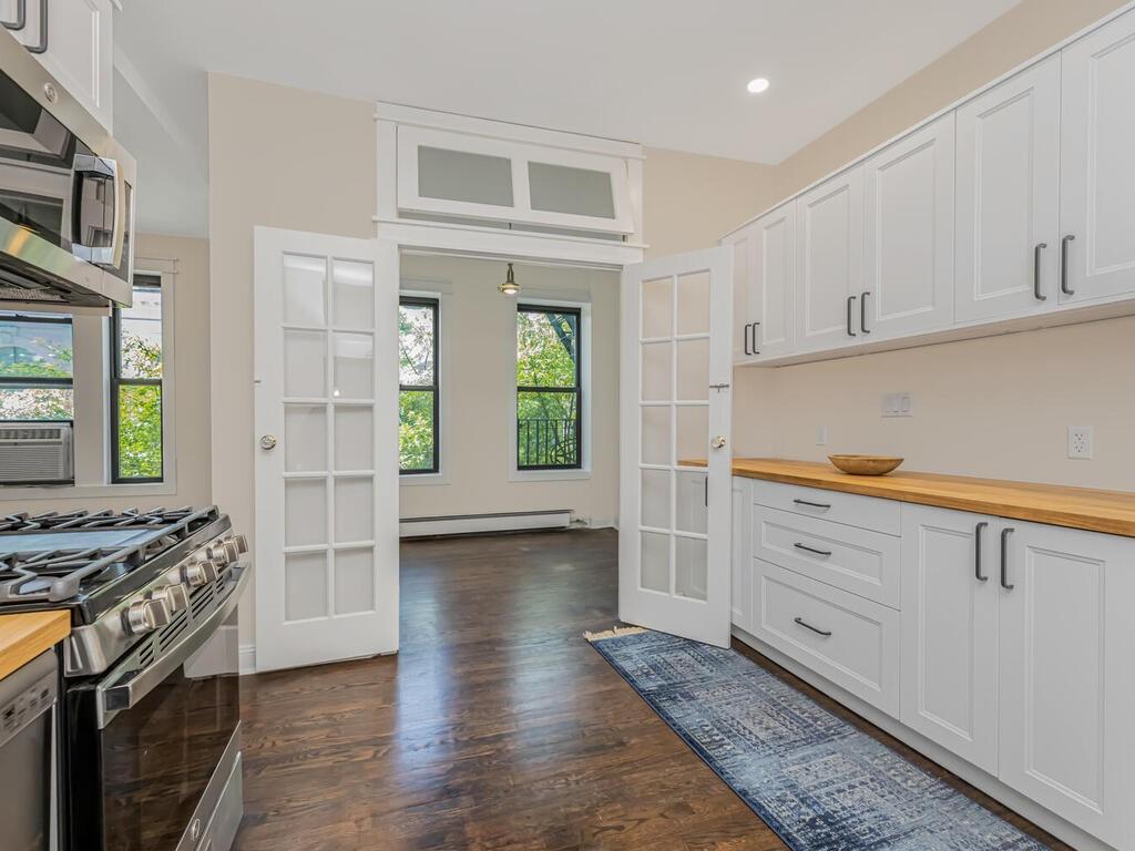 a kitchen with stainless steel appliances granite countertop a stove and a refrigerator