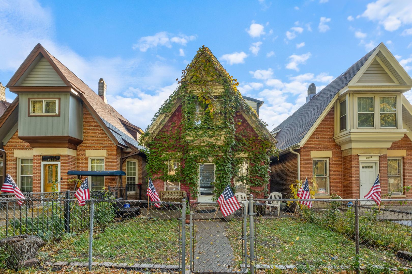 a view of a brick house with a yard and plants