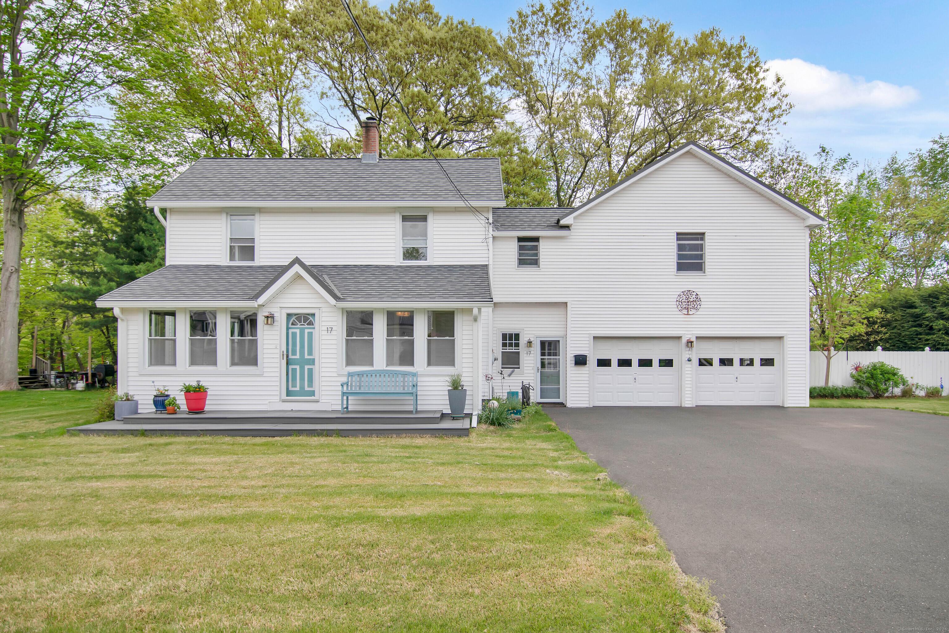 a front view of a house with a yard outdoor seating and garage