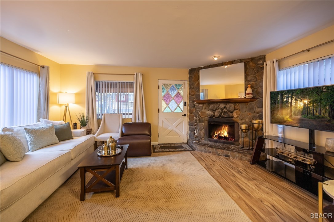 a living room with furniture a flat screen tv and a fireplace