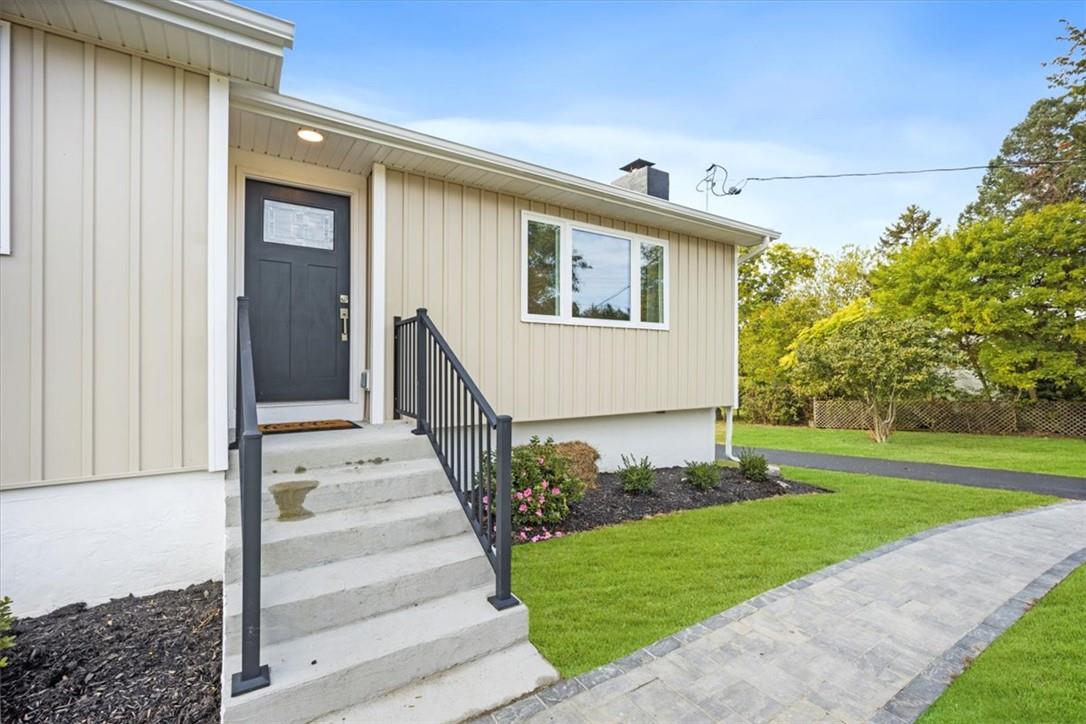 View of exterior entry featuring a yard