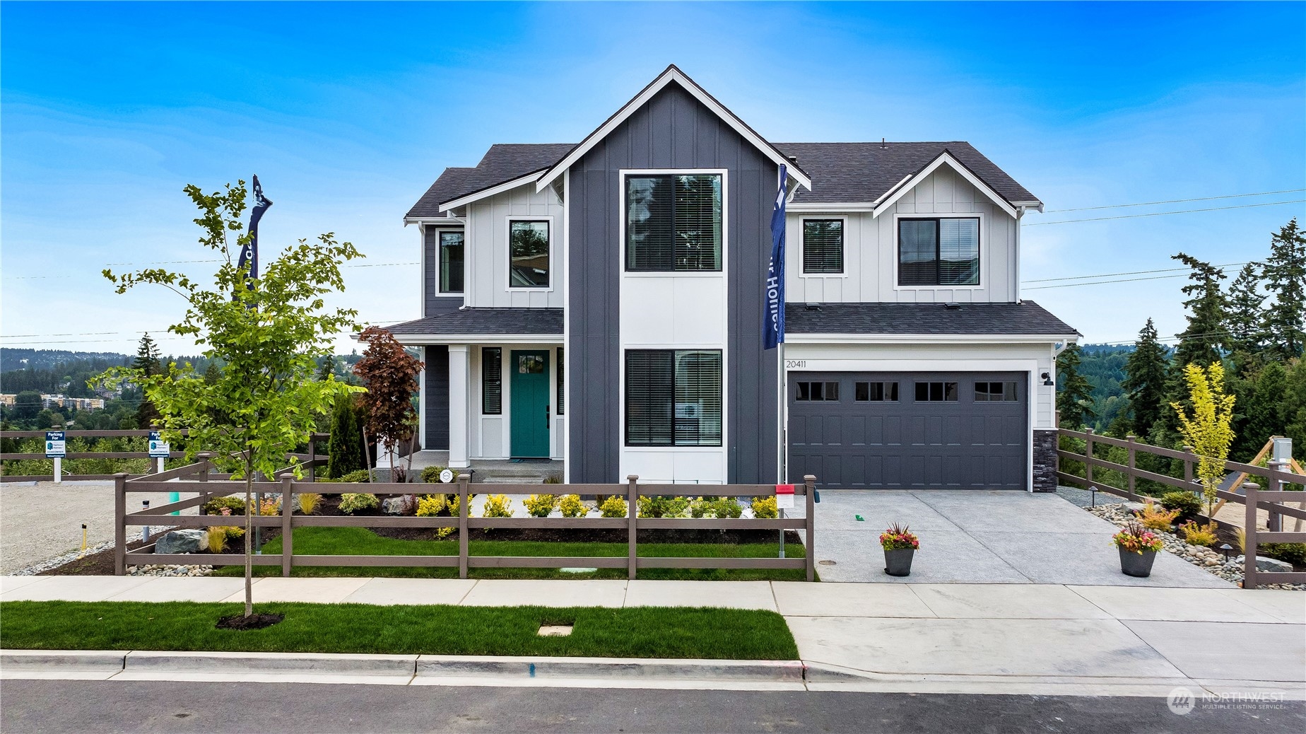 a front view of a house with a yard and potted plants