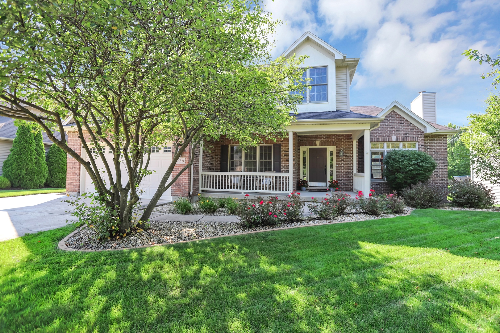 a view of a house with a yard and tree s