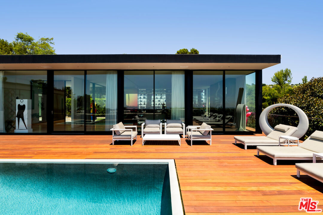 a view of swimming pool with outdoor seating and a patio