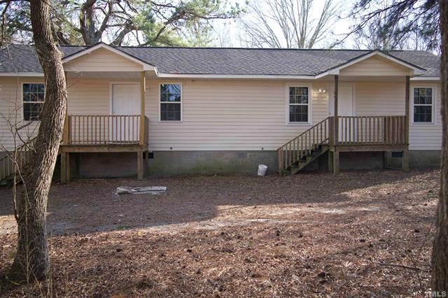 a view of a house with a yard and garage