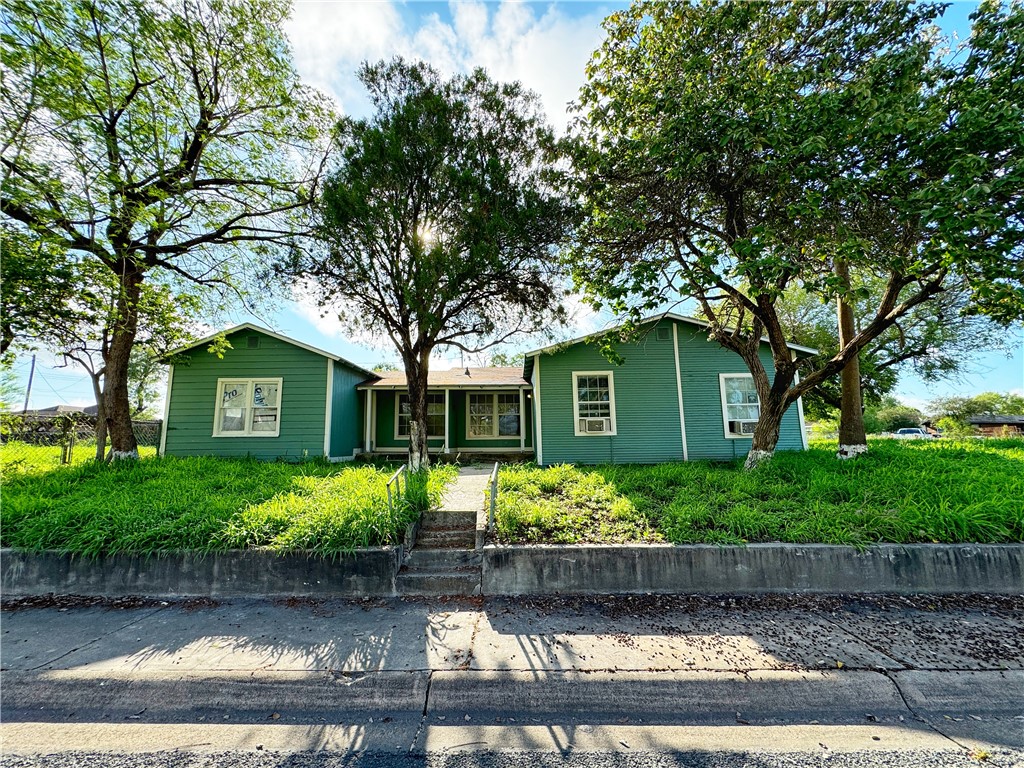 front view of a house with a tree