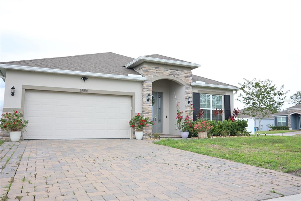 a front view of a house with a yard and garage