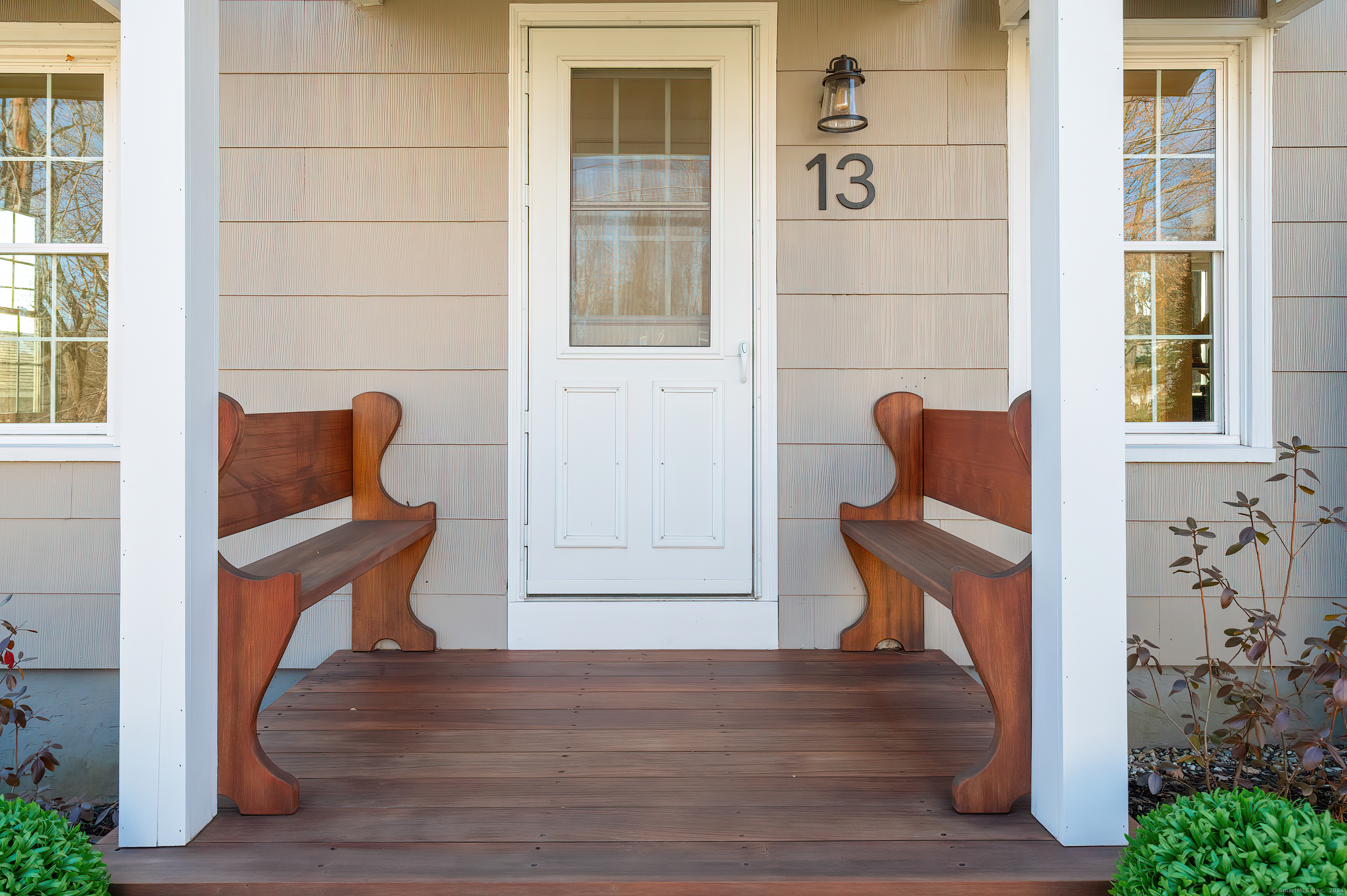 a wooden bench sitting in front of a building