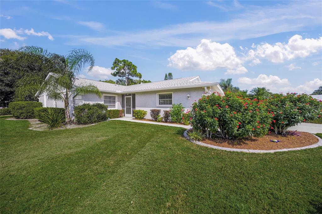 a view of a house with a backyard