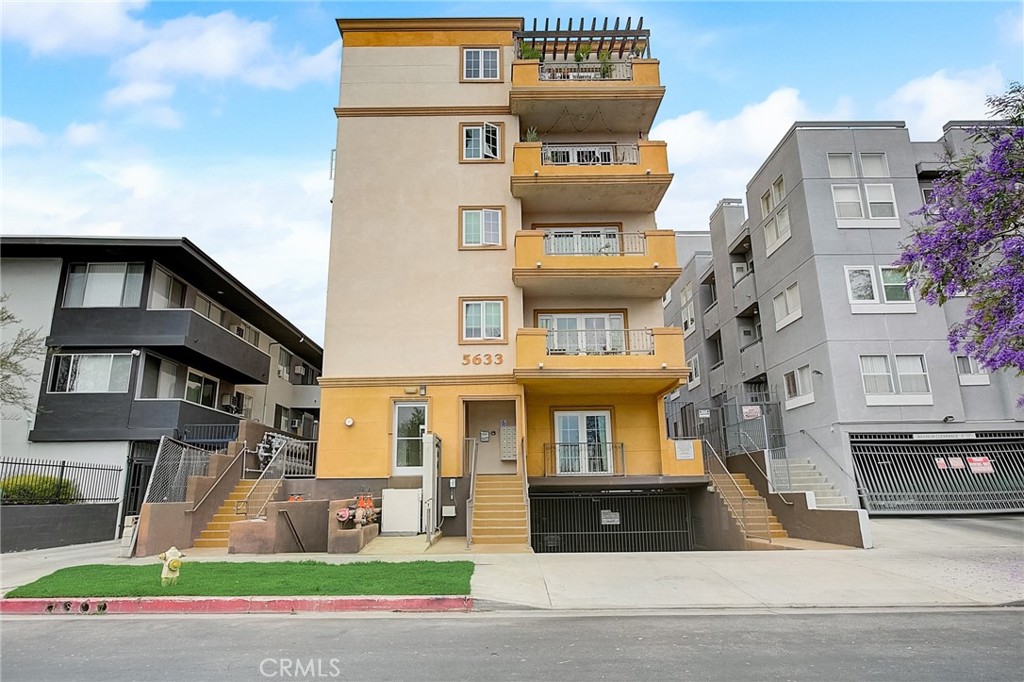 a front view of a residential apartment building with a yard