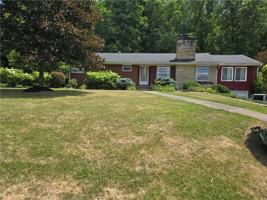 a front view of a house with a garden