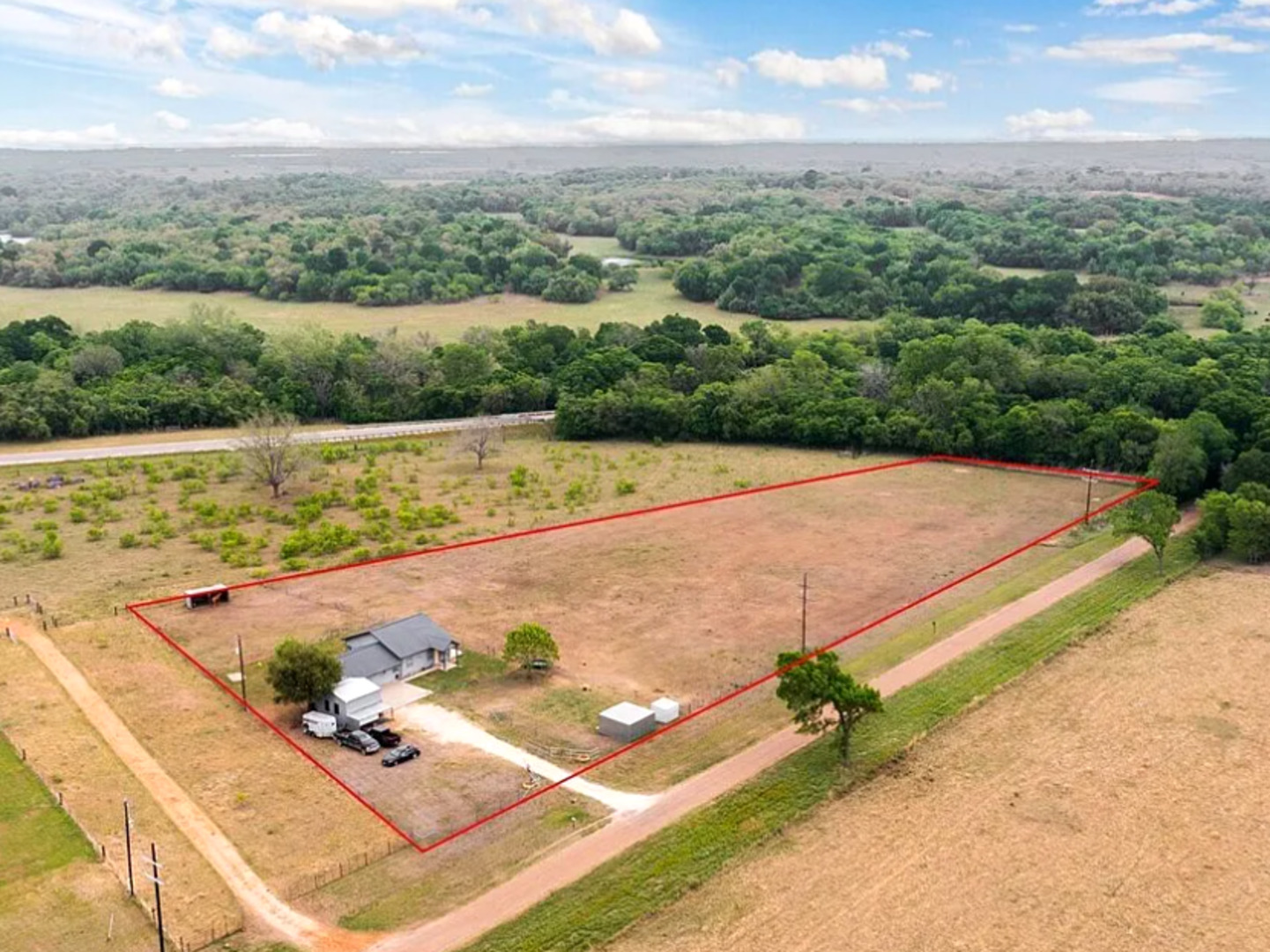 an aerial view of a pool yard and mountain view in back