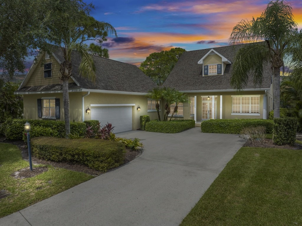 a front view of a house with a yard and outdoor seating