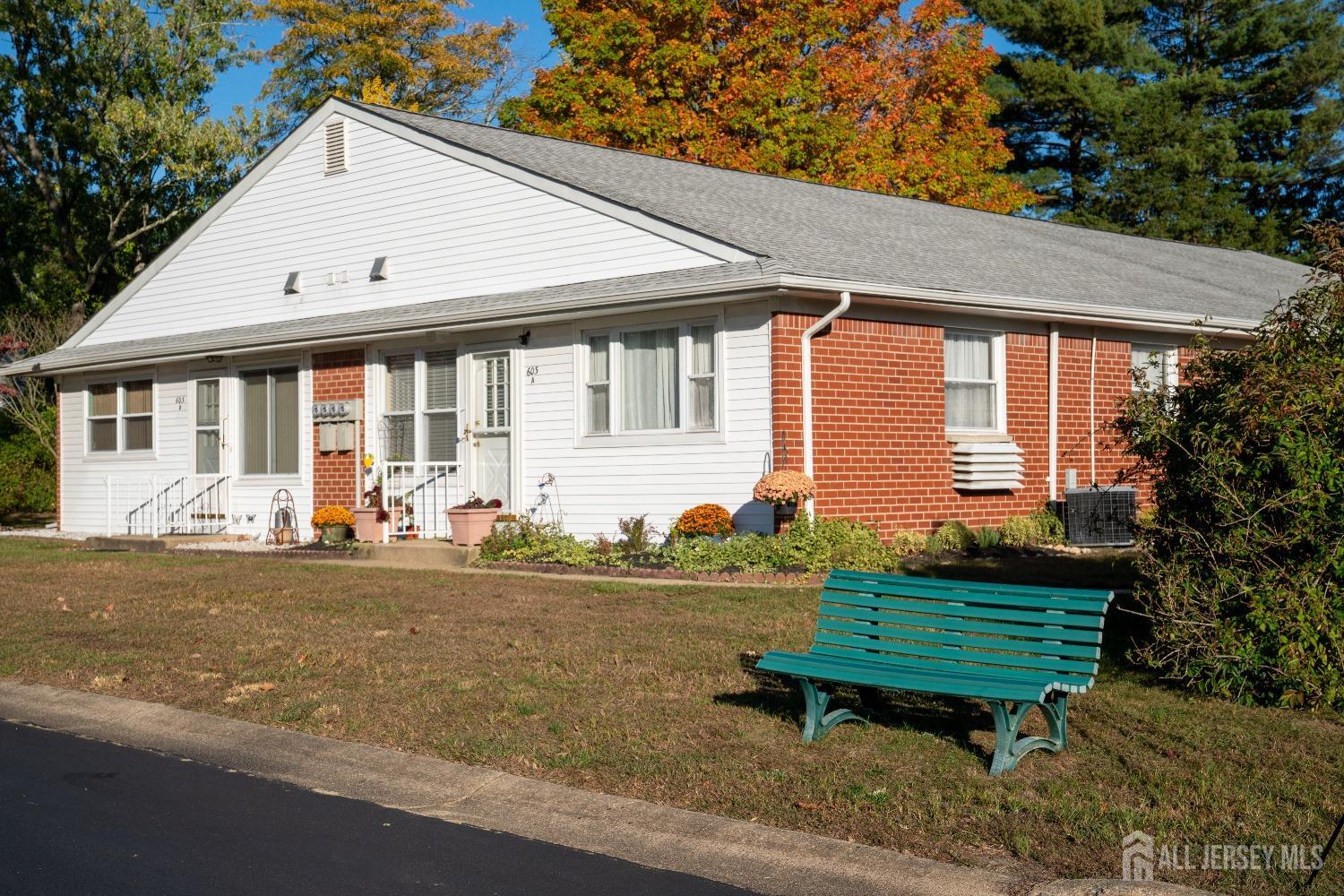 a view of a house with backyard and sitting area