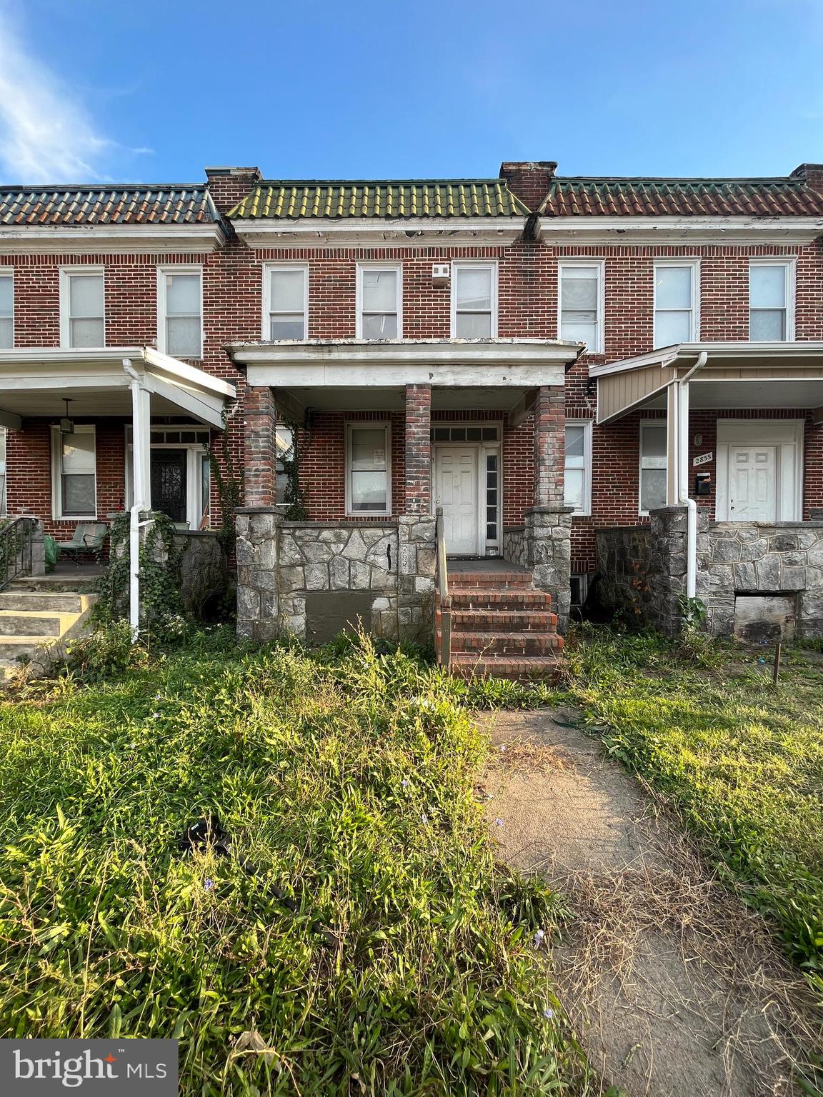 a front view of a residential apartment building with a yard