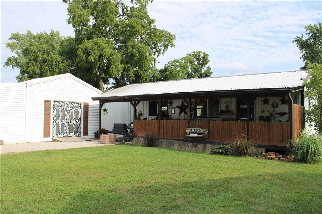 a view of a house with backyard and porch