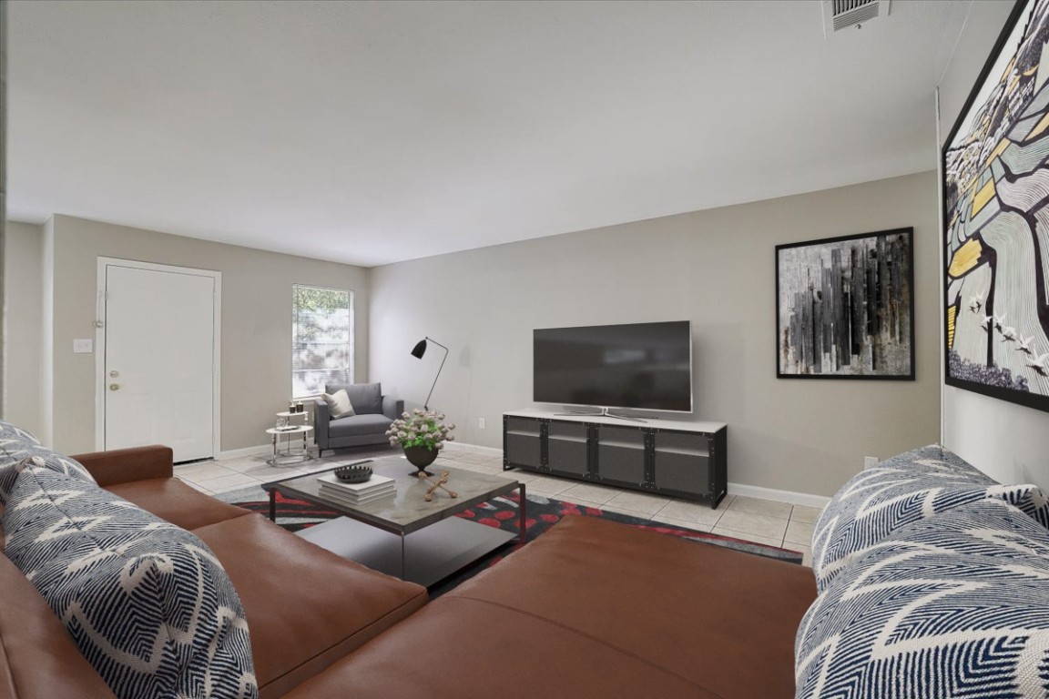 a living room with furniture and a flat screen tv