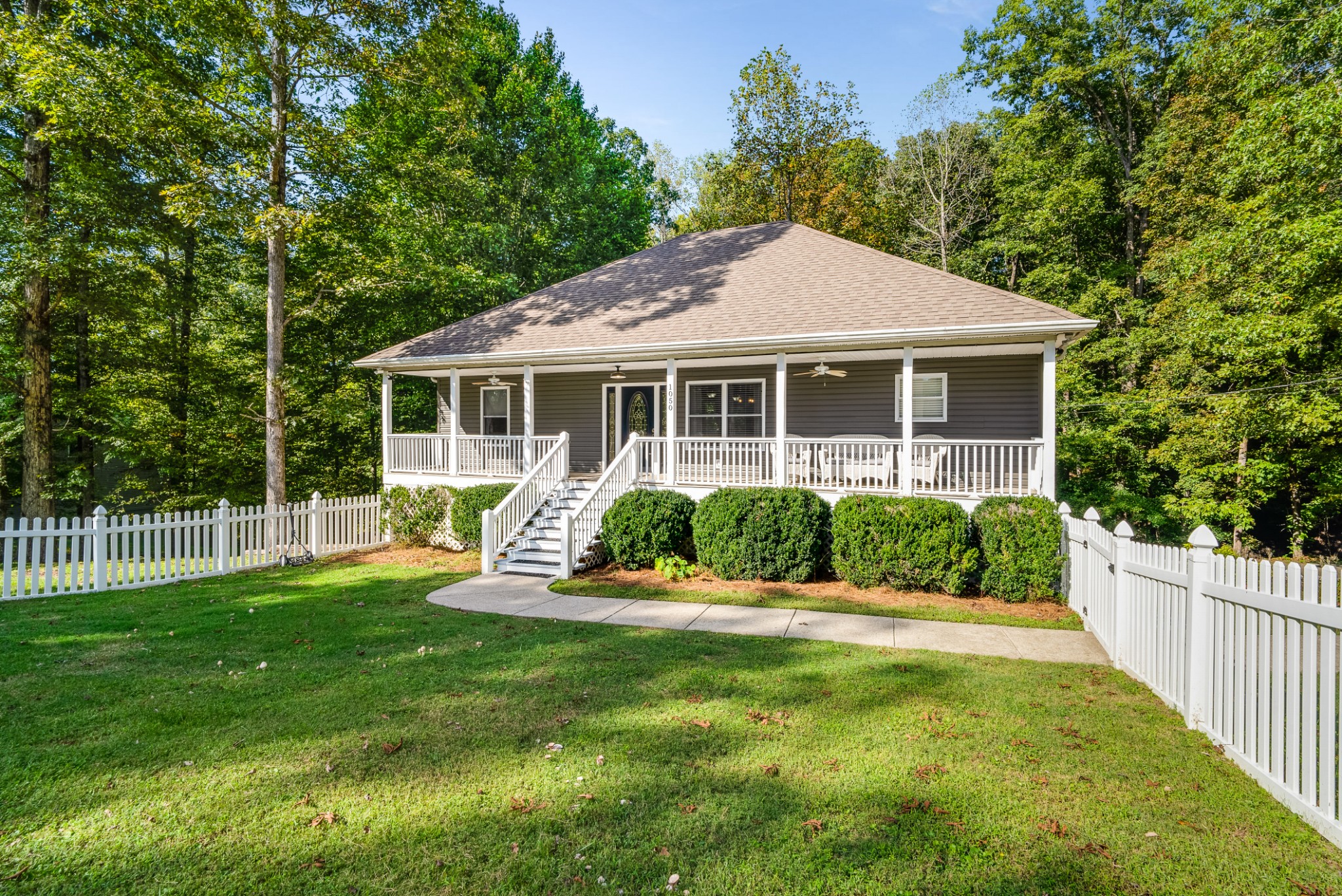 a front view of house with yard and green space