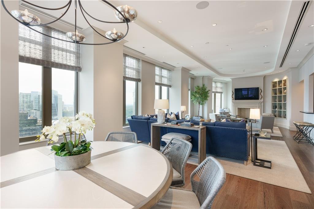 a living room with furniture a chandelier and a large window