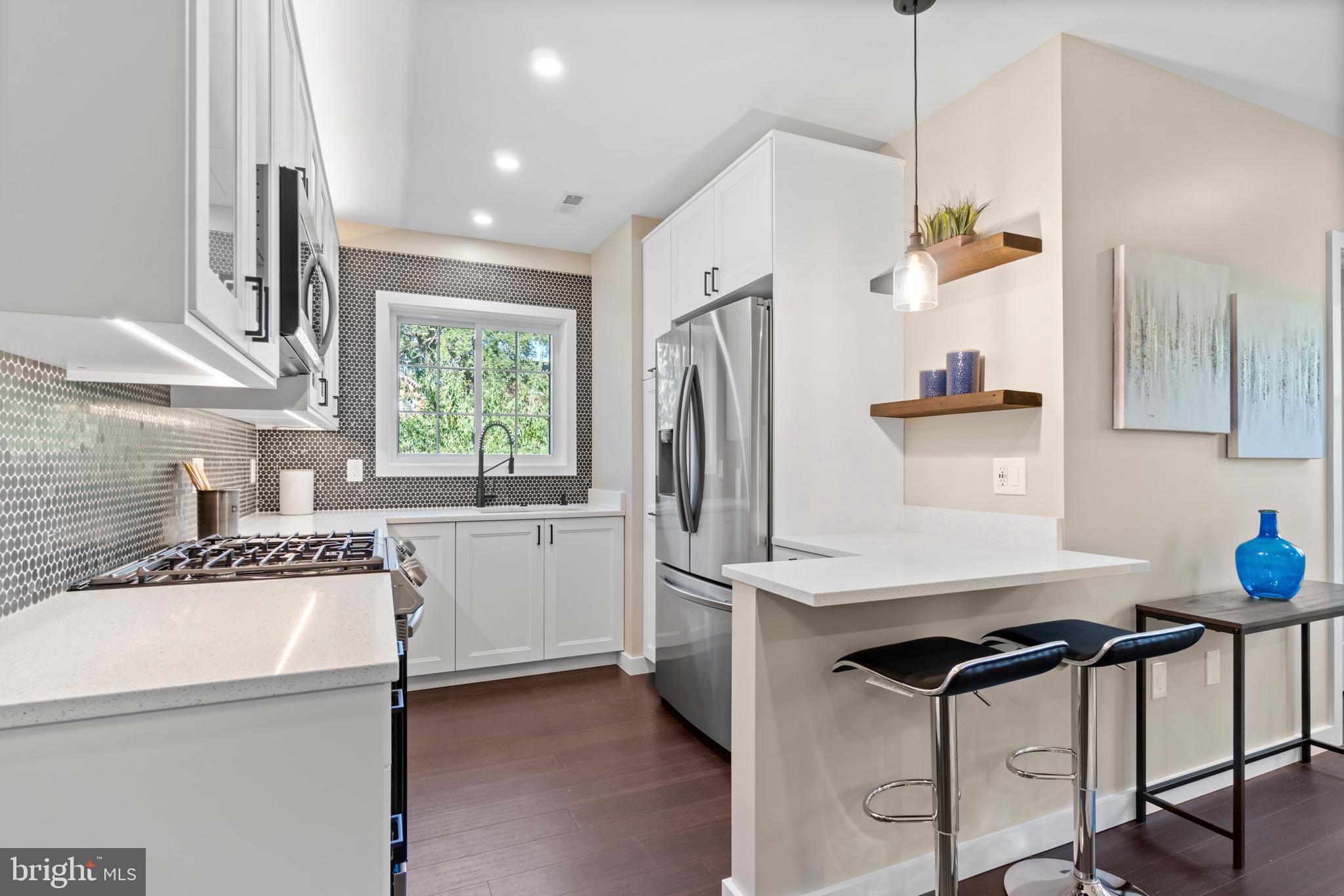 a kitchen with a refrigerator a sink and a stove