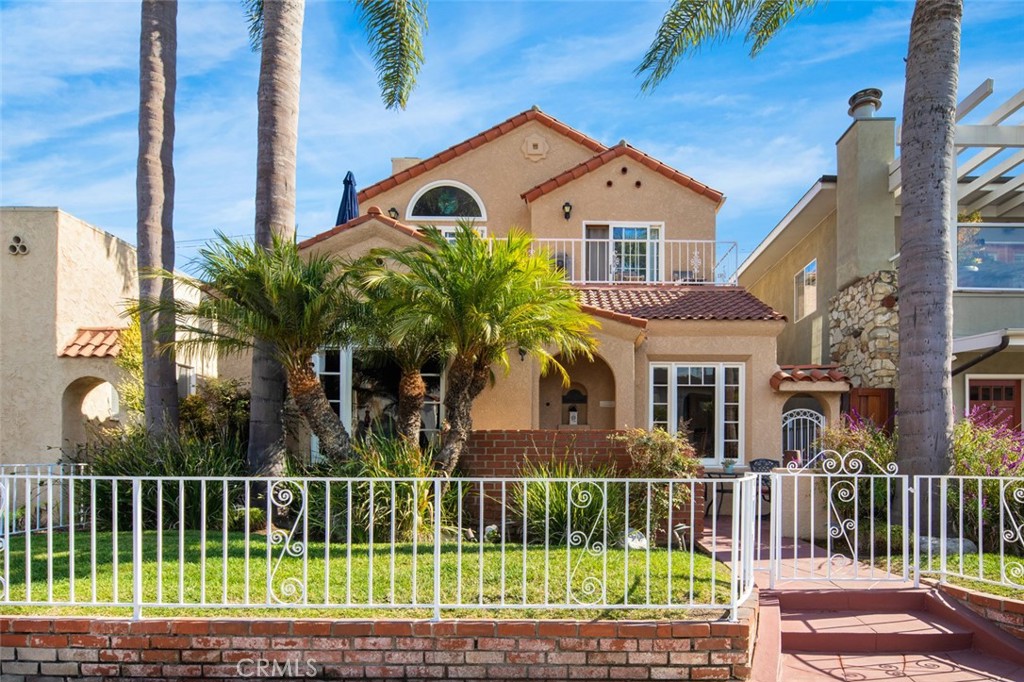 a front view of a house with plants