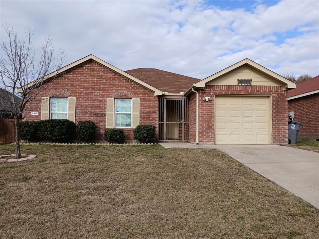 a front view of a house with yard and garage