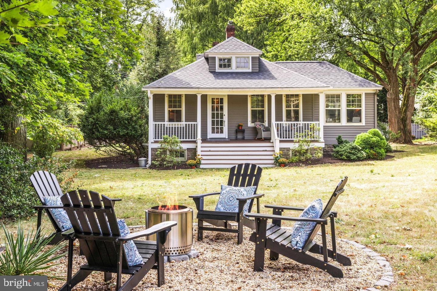 a front view of a house with swimming pool and porch