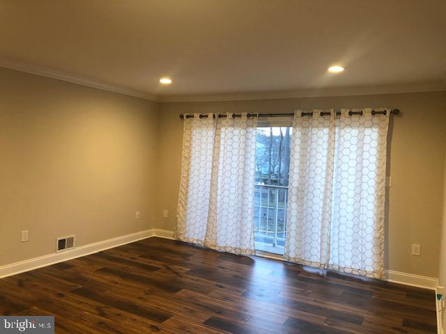 an empty room with wooden floor and a window