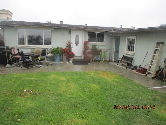 a backyard of a house with table and chairs