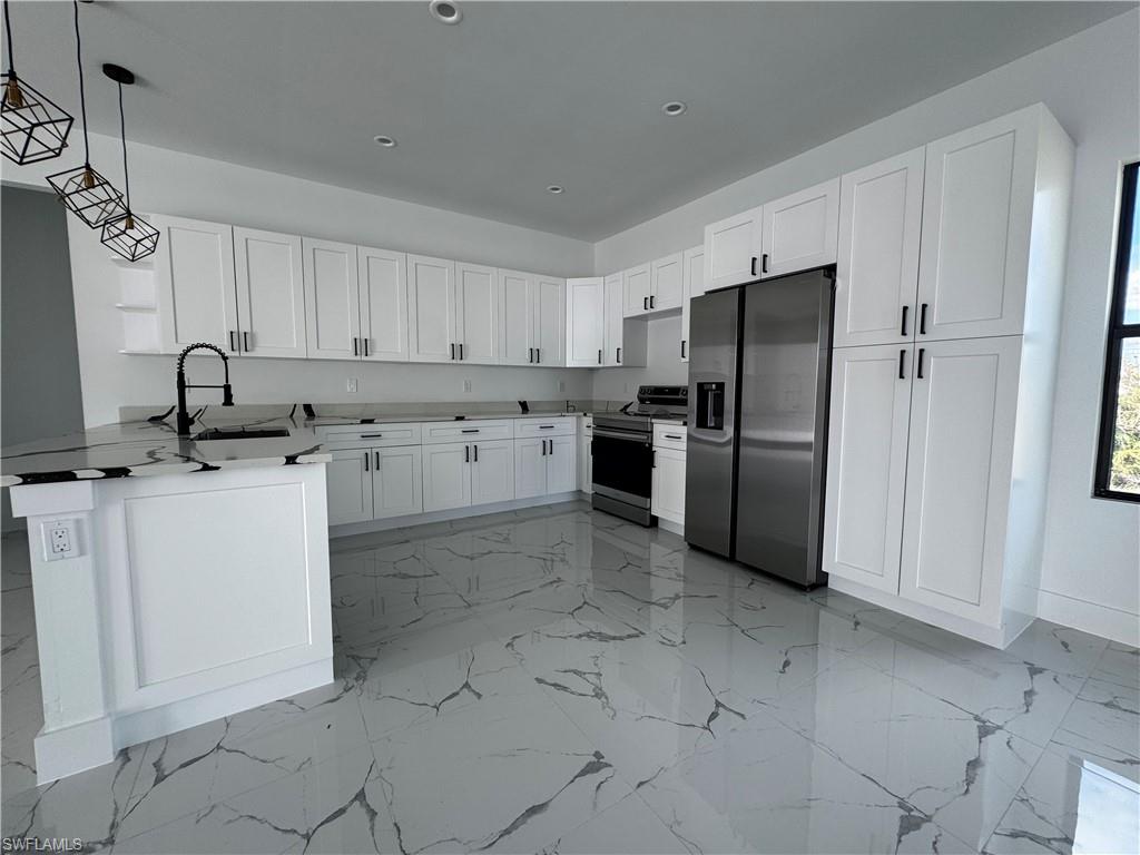 a kitchen with a refrigerator sink and cabinets