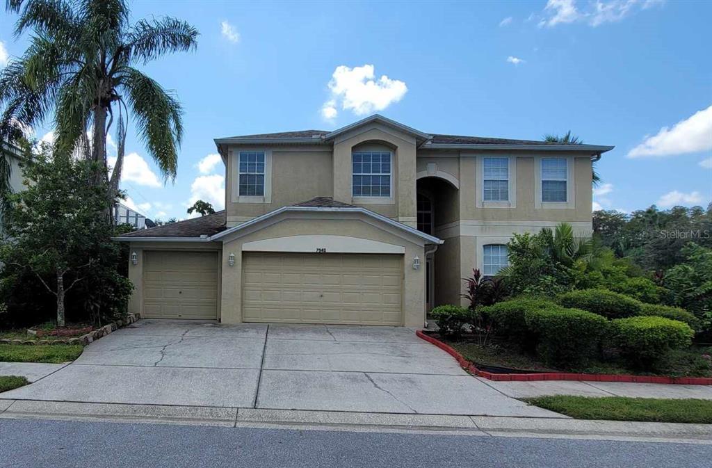 a front view of a house with a yard and garage