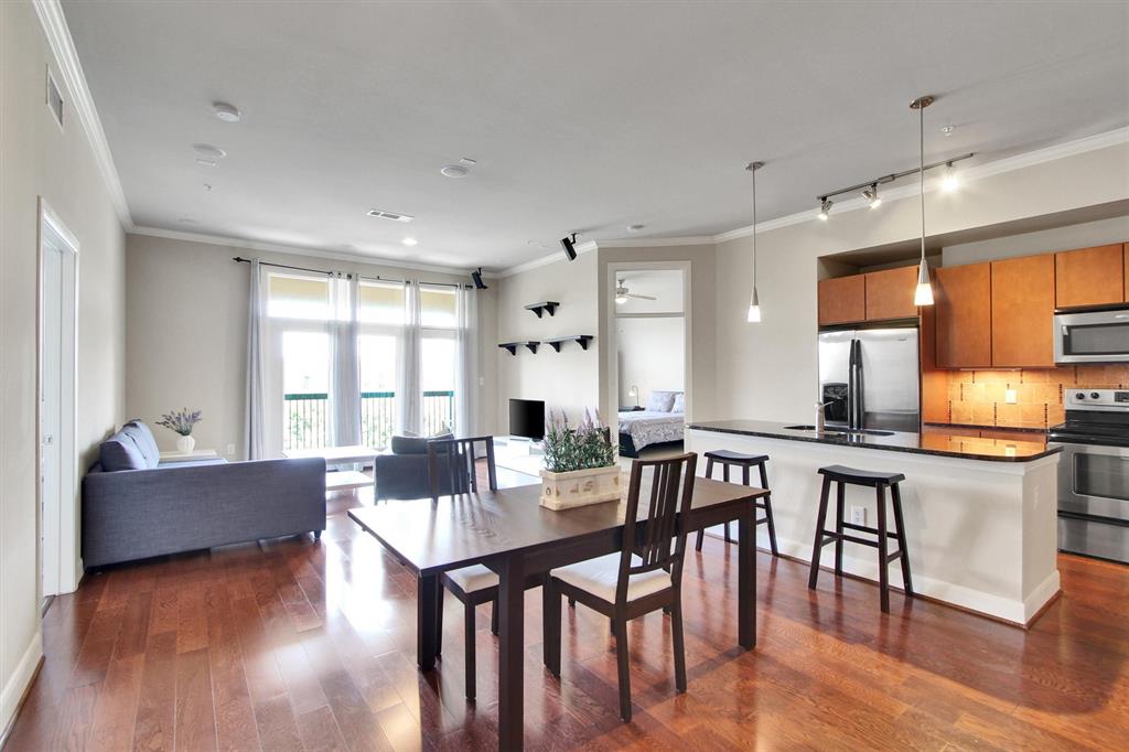 a view of a dining room with furniture and wooden floor