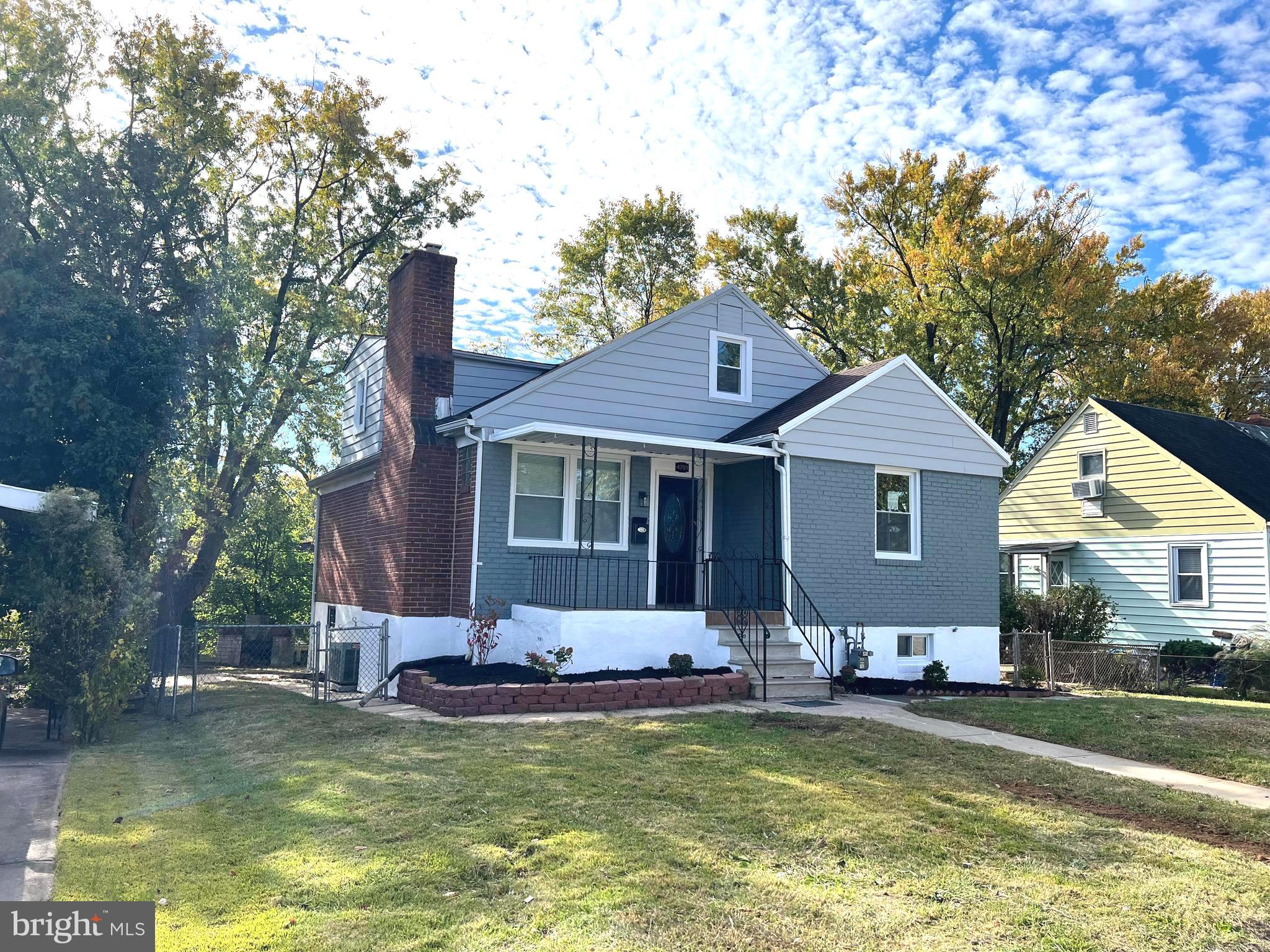 a front view of a house with swimming pool and furniture