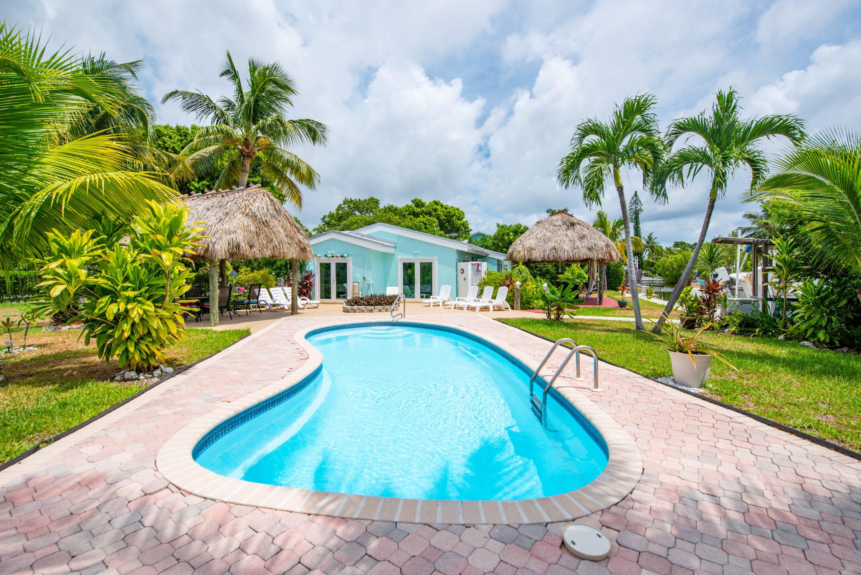 a swimming pool with outdoor seating and yard