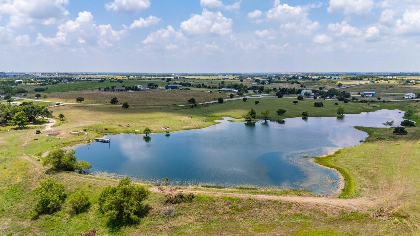 a view of a lake with houses in the back