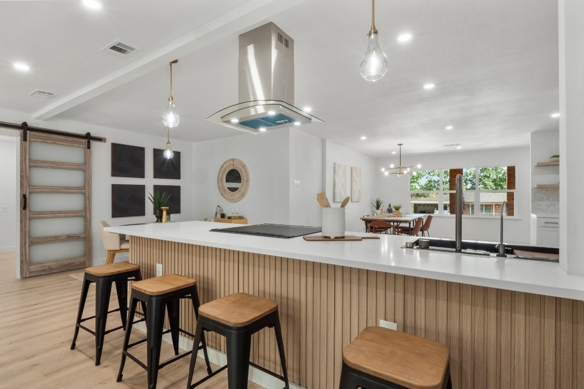 This kitchen has an open floor plan, quartz countertops, and lots of natural light. It's a great space for cooking and entertaining.