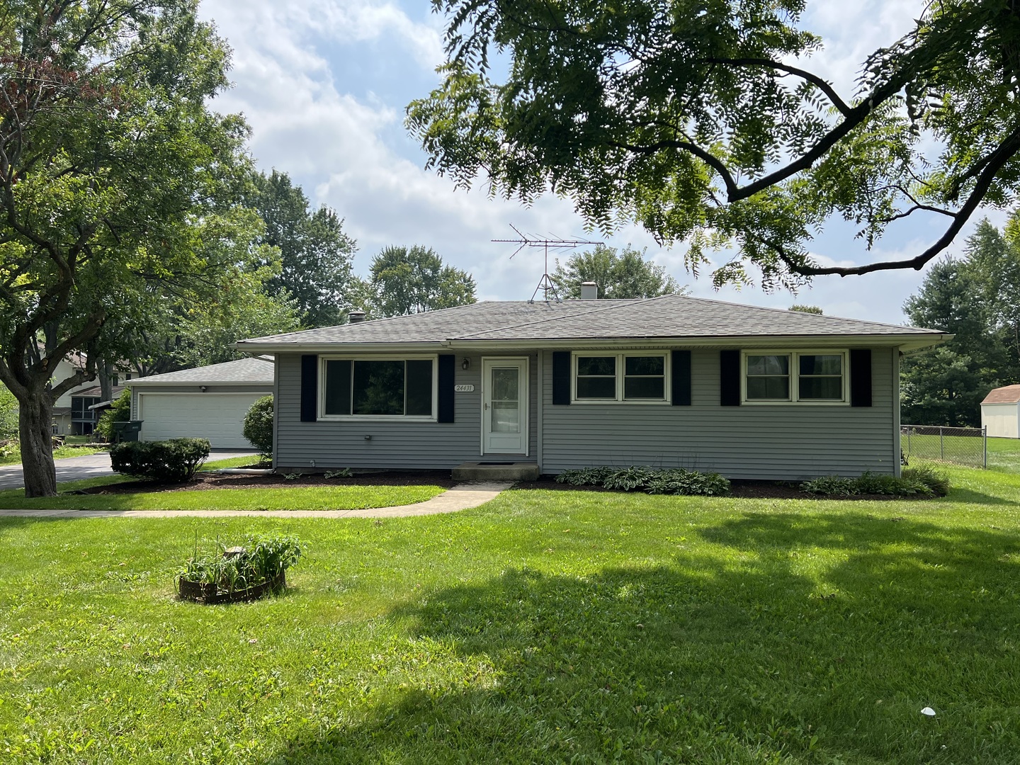 a view of a house with a yard and a patio