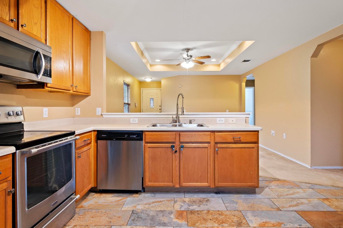 a kitchen with stainless steel appliances granite countertop a sink and a microwave