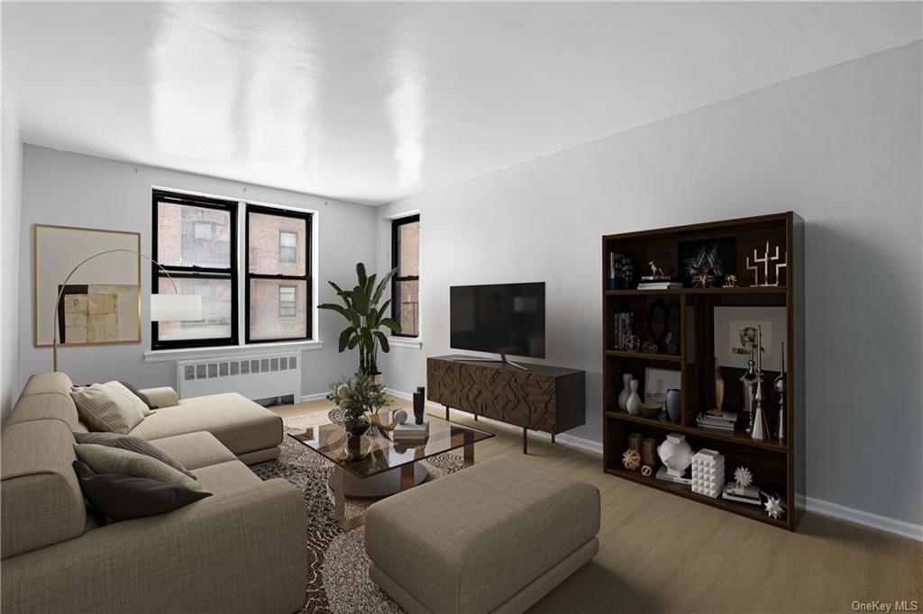 a living room with furniture a window and a flat screen tv